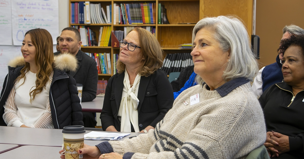 Minneapolis Foundation board members listening to a presentation at a school