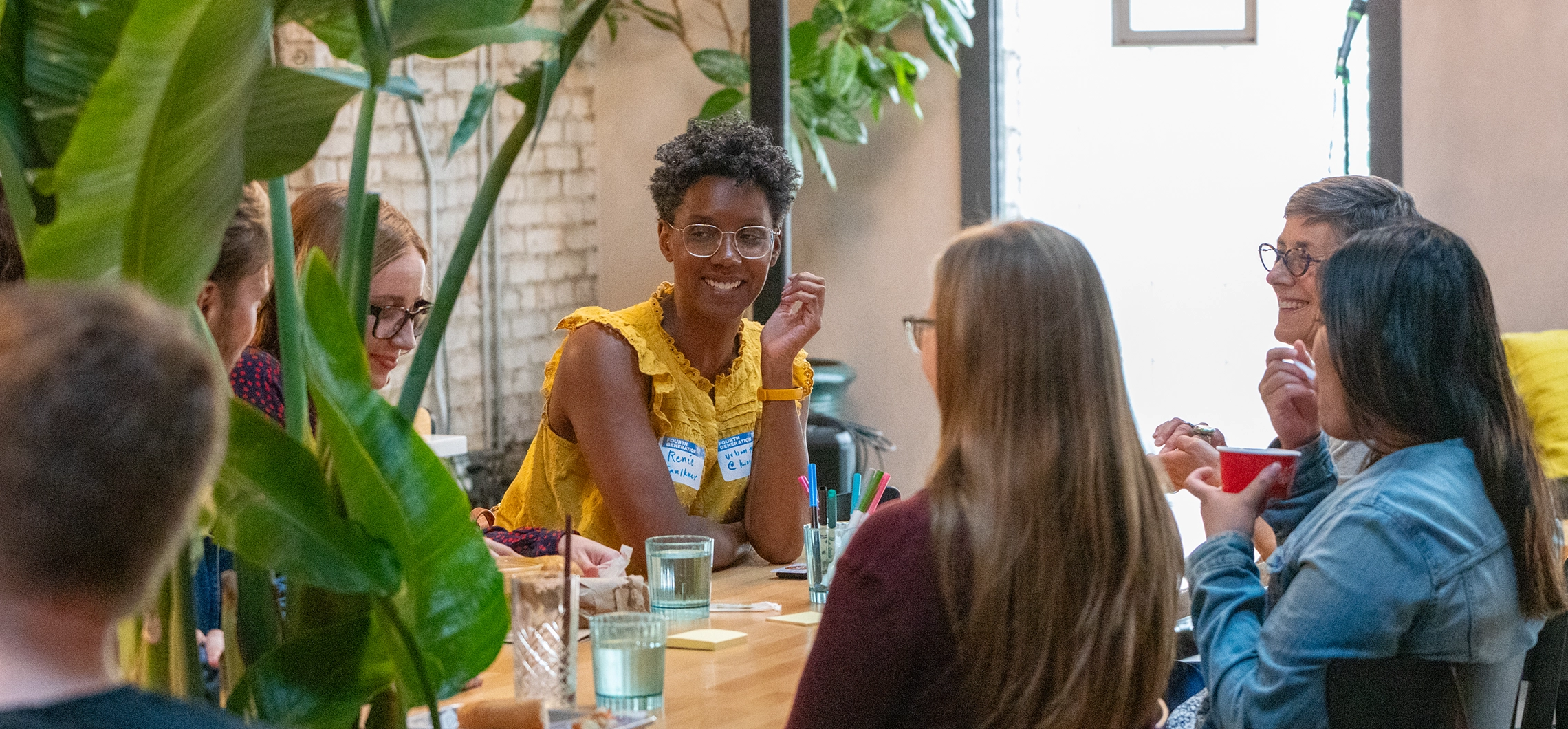 adults sitting a table and smiling